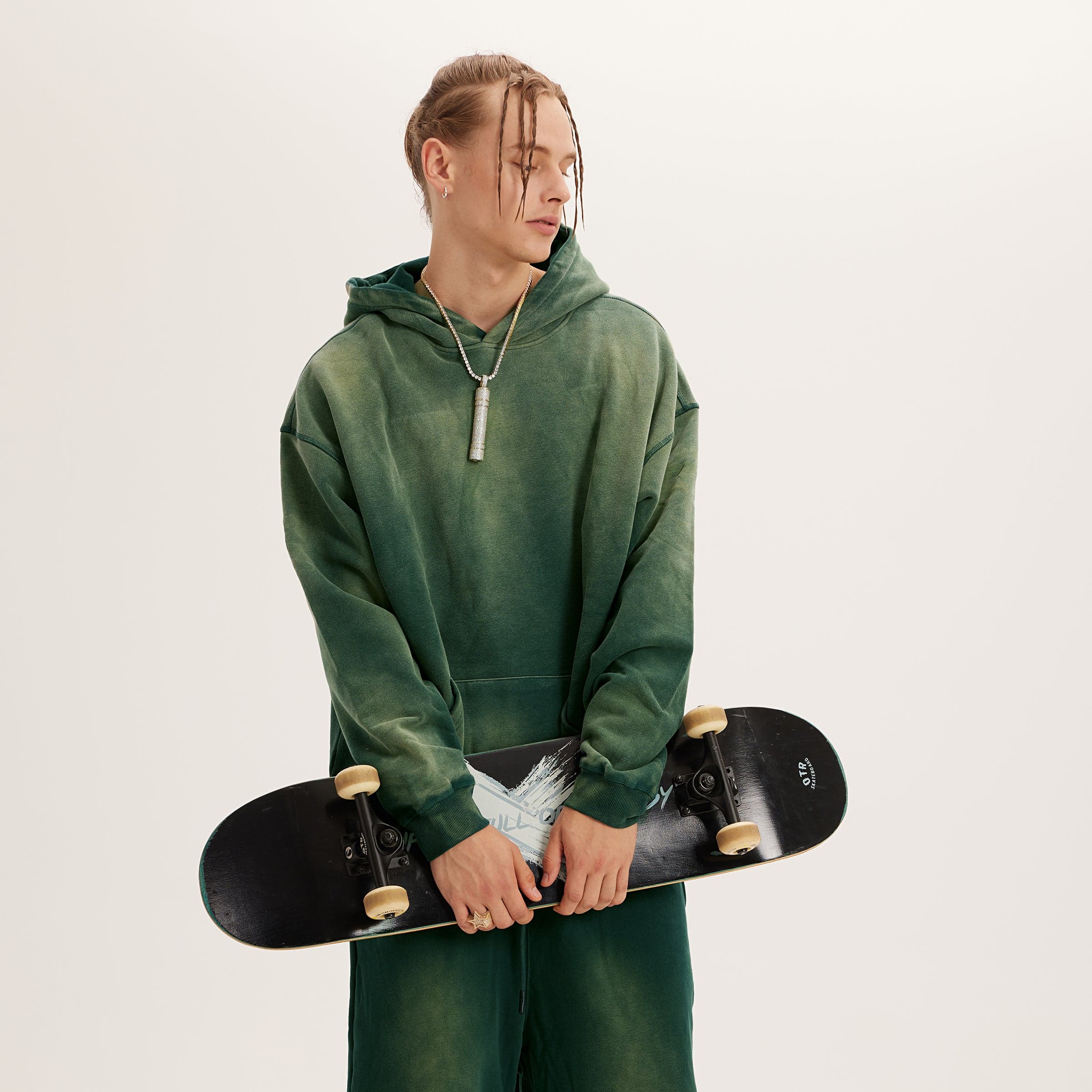 Aether Rune oversized graphic hoodie male model angled fit view holding skateboard