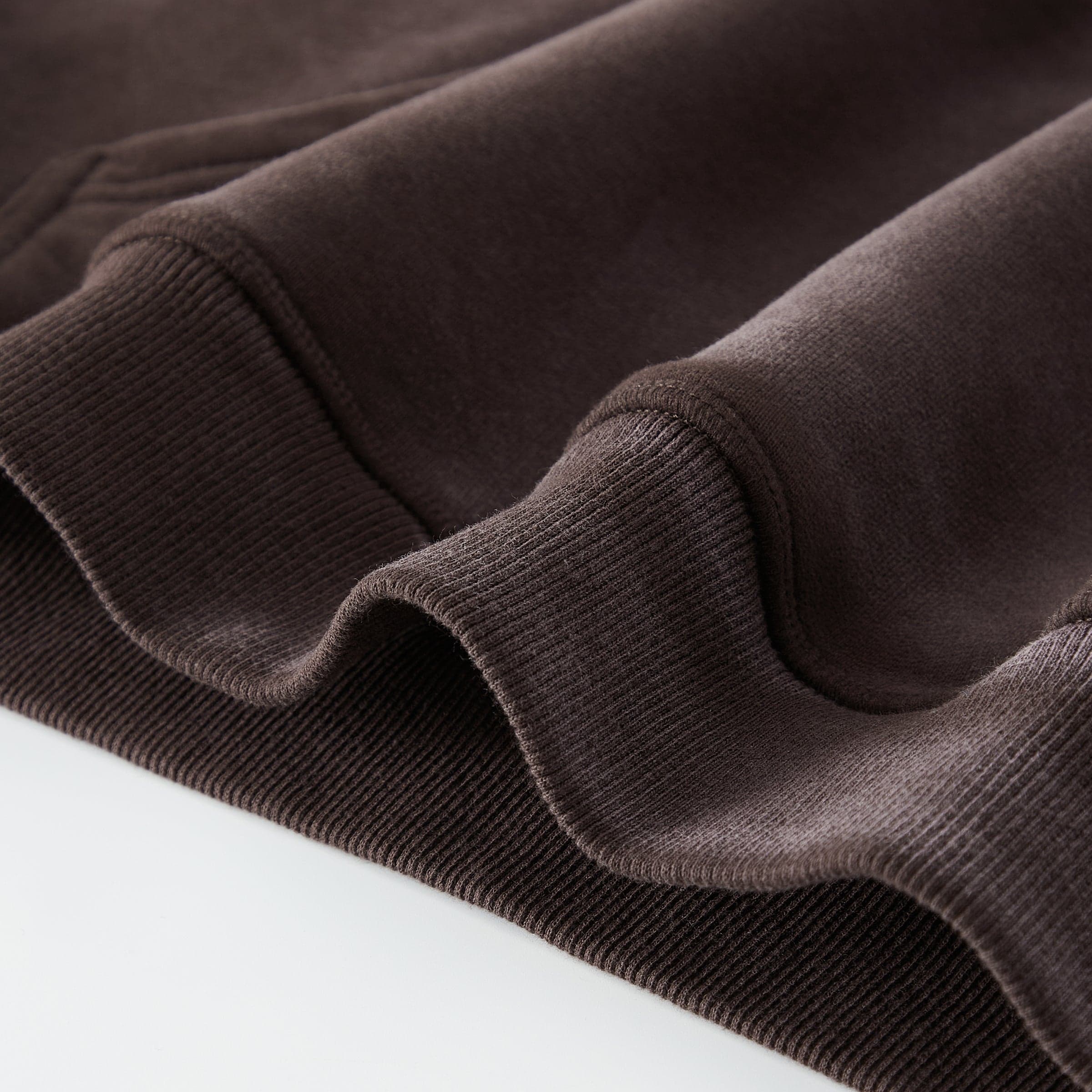 Aether Rune media image showing ribbed hem detail on washed hoodie