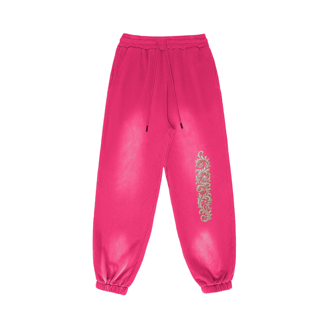 Akant Noir embroidered sweatpants front view in washed pink with full leg embroidery