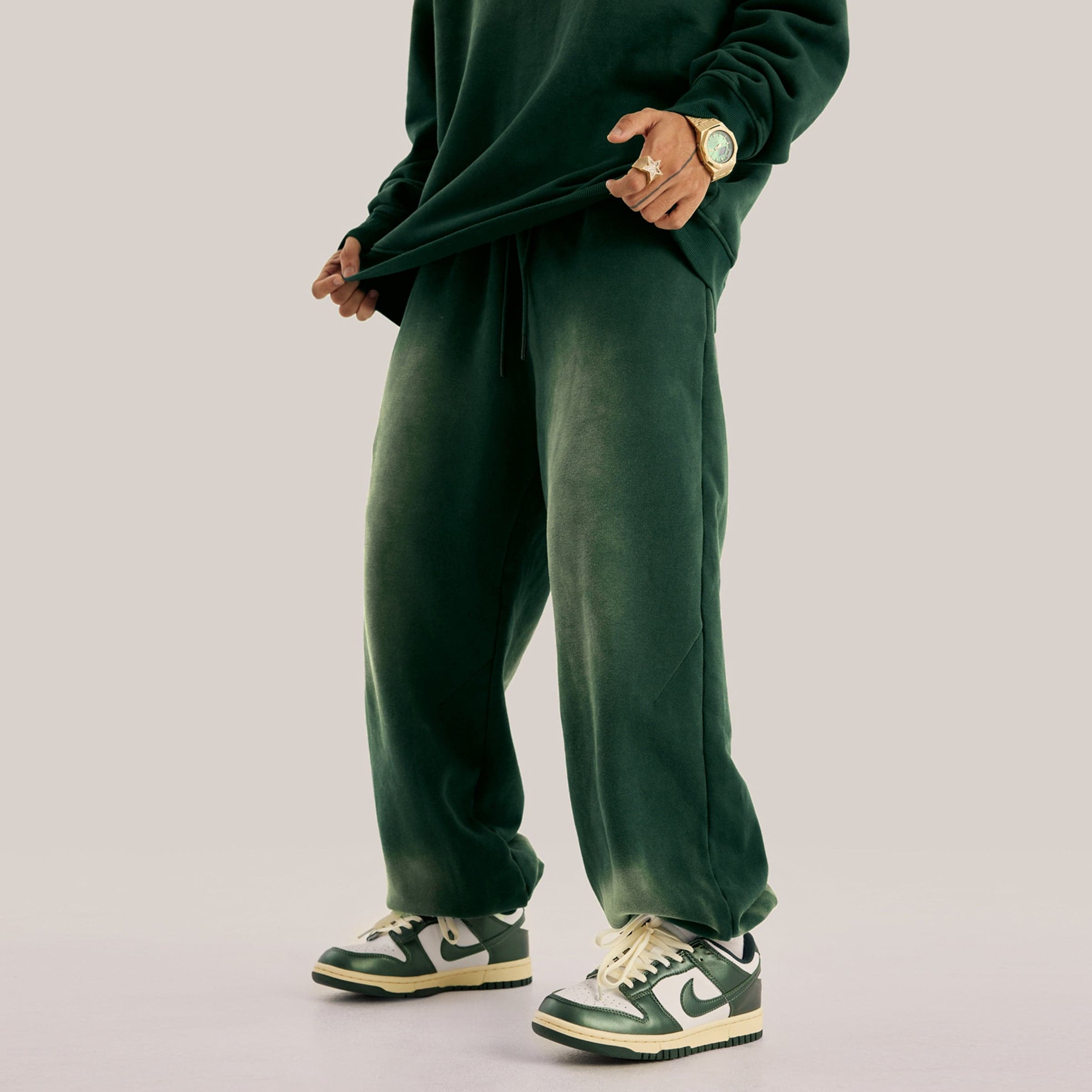 Akant Noir embroidered sweatpants angled side fit view on model in green sample color