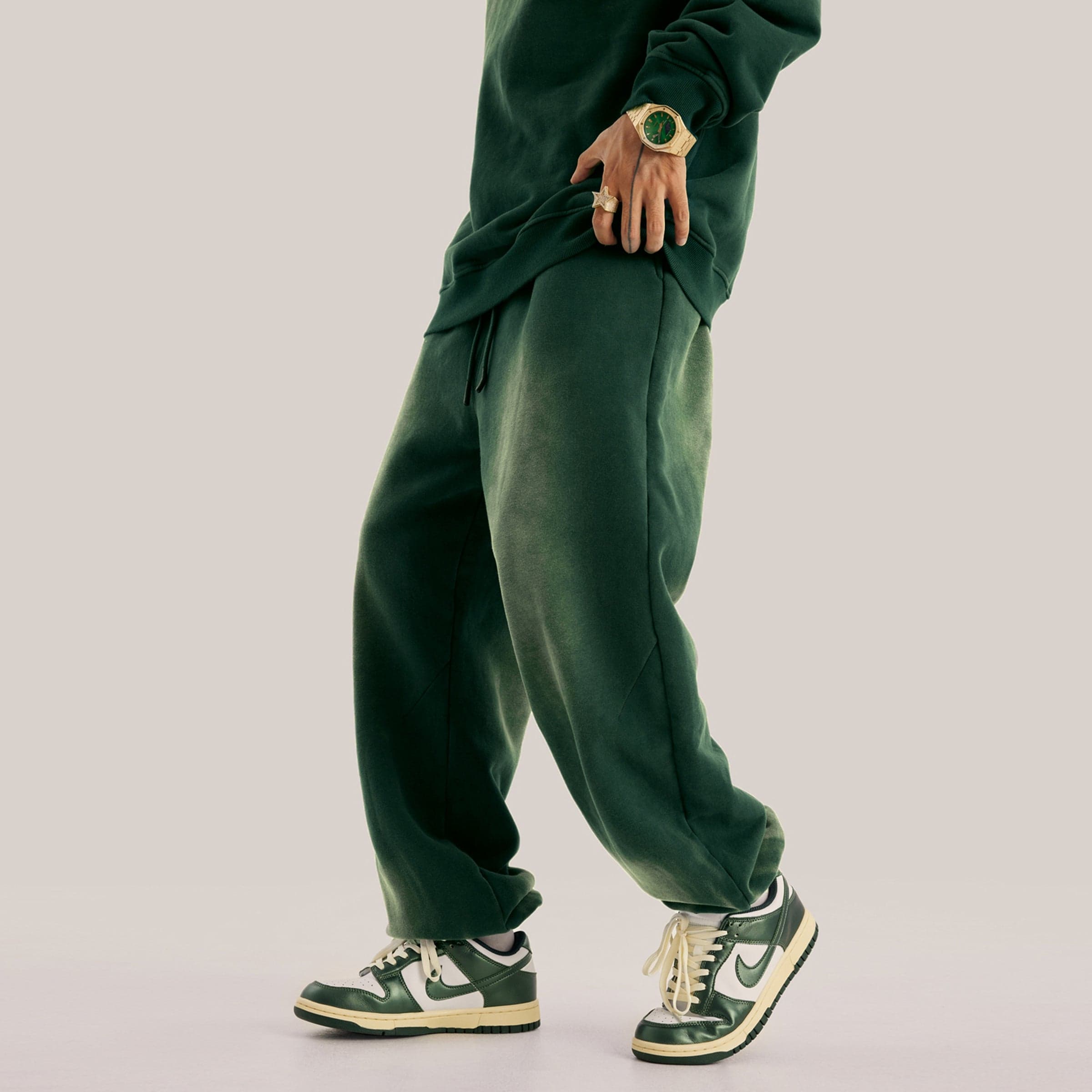 Akant Noir embroidered sweatpants side lower fit view on model in green sample color