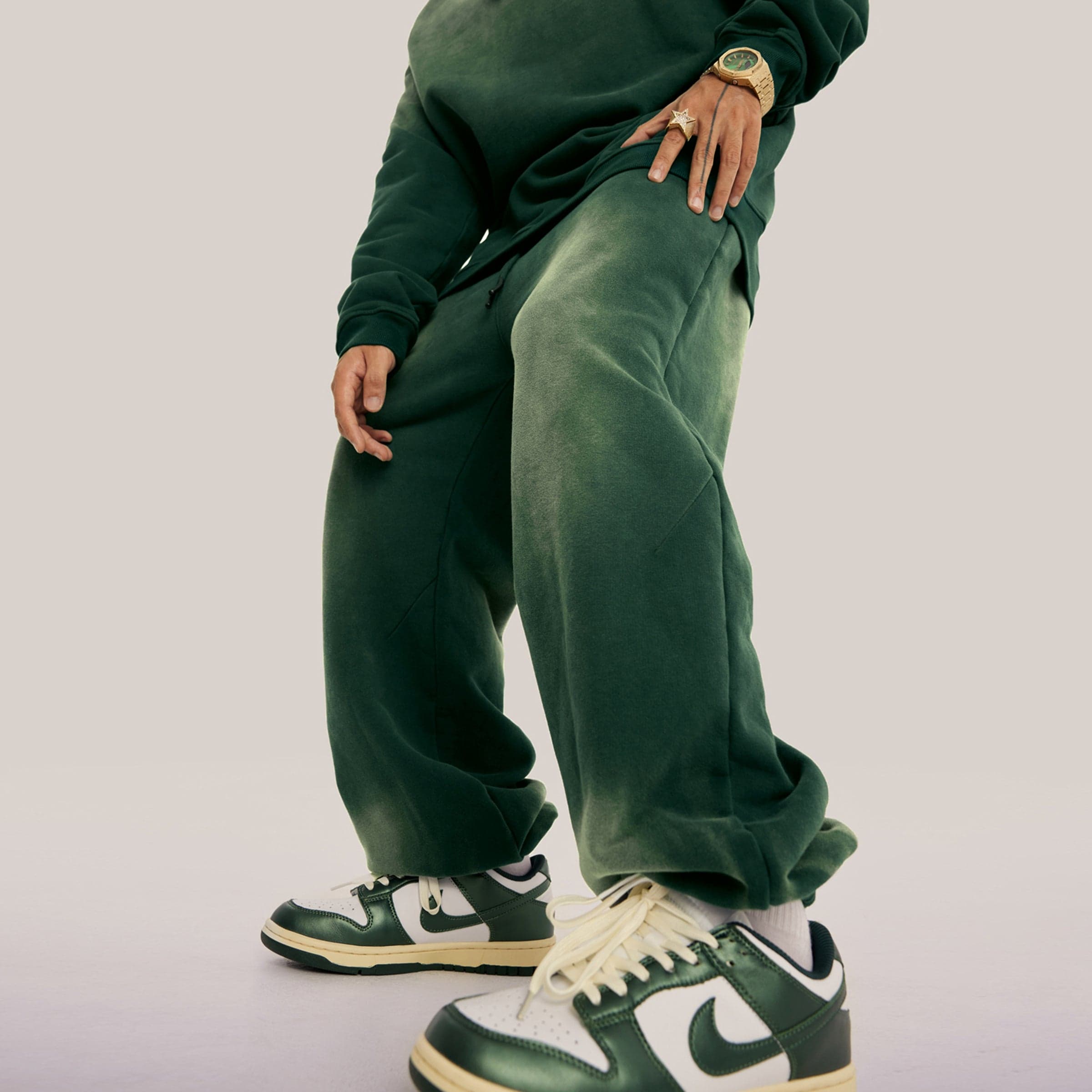 Akant Noir embroidered sweatpants angled front fit view on model in green sample color