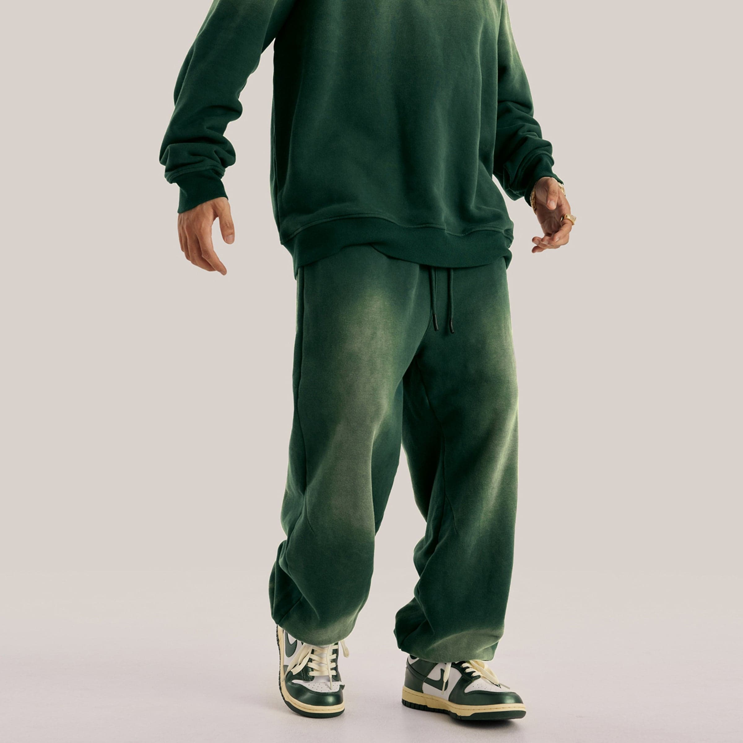 Akant Noir embroidered sweatpants back lower fit view on model in green sample color