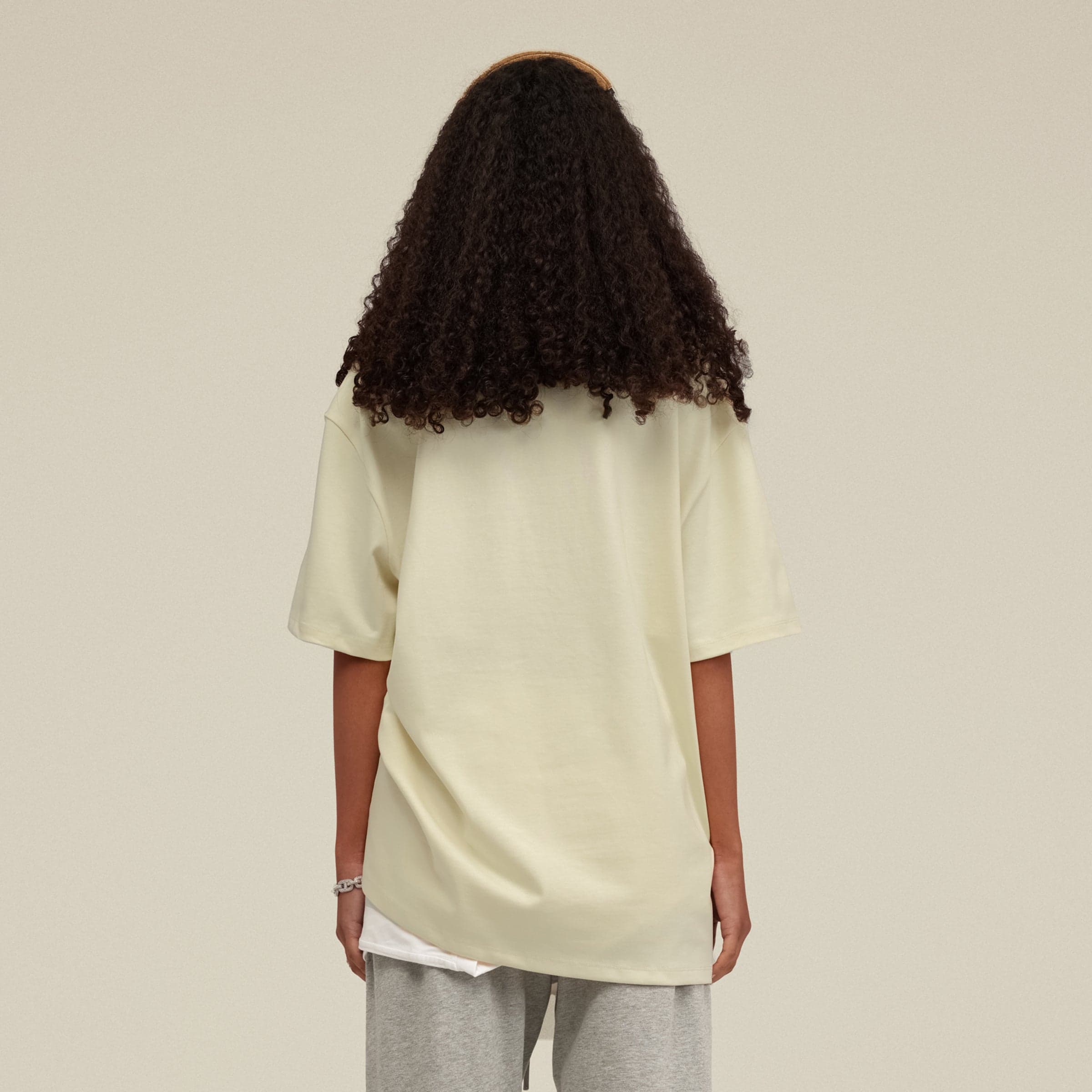 Photo taken from behind while wearing an Astra oversized graphic tee for women.