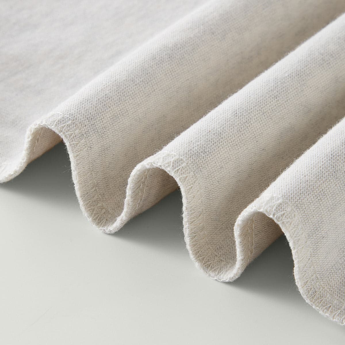 Close-up detail of the fabric lining of the AURA oversize graphic t-shirt.