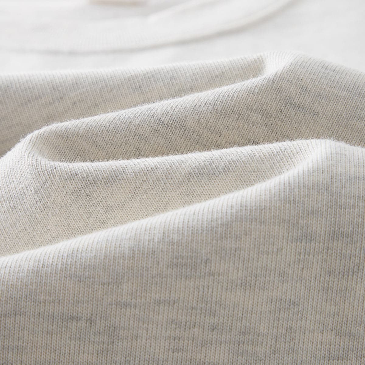 AURA oversized graphic tee fabric drape close-up detail