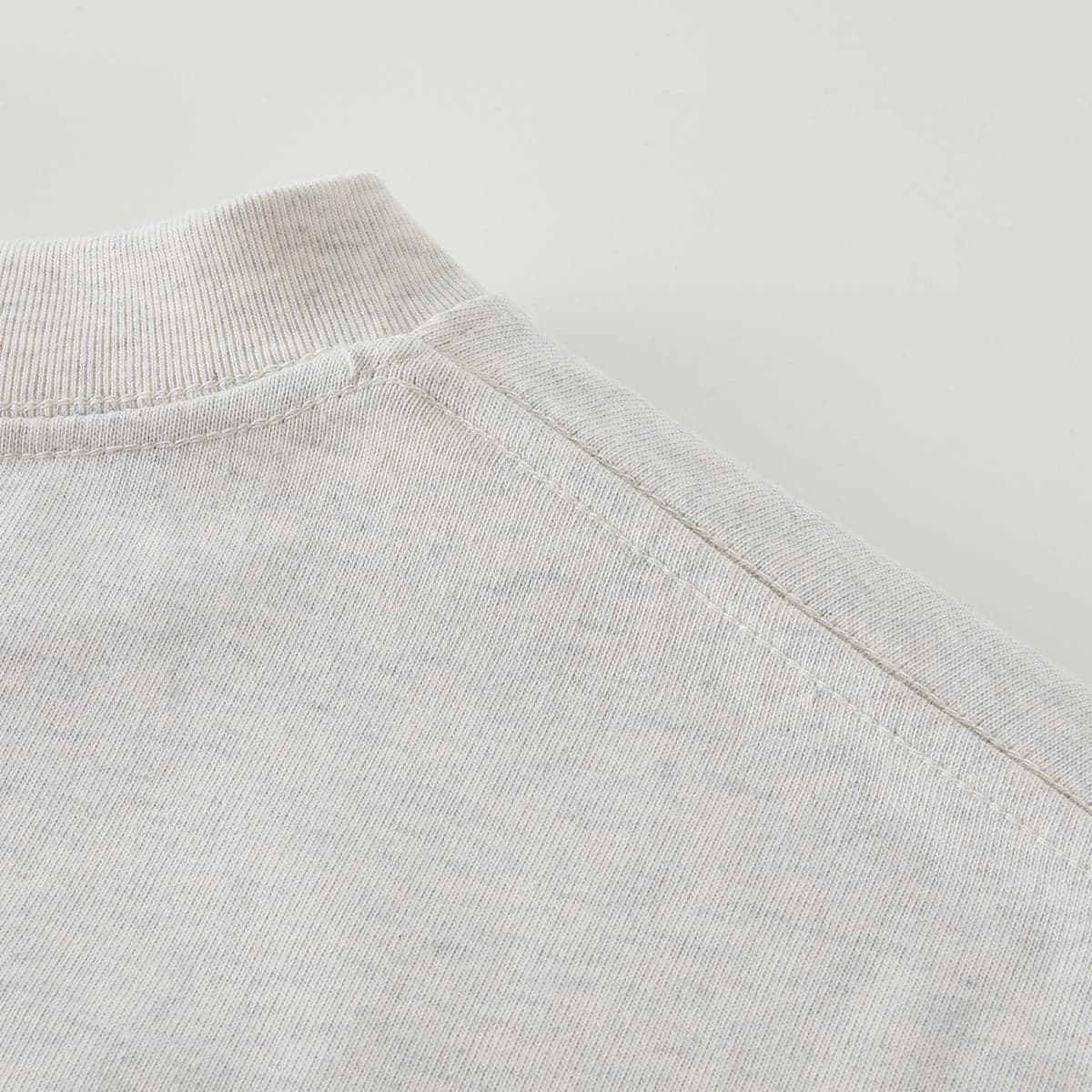 AURA oversized graphic tee shoulder seam close-up detail