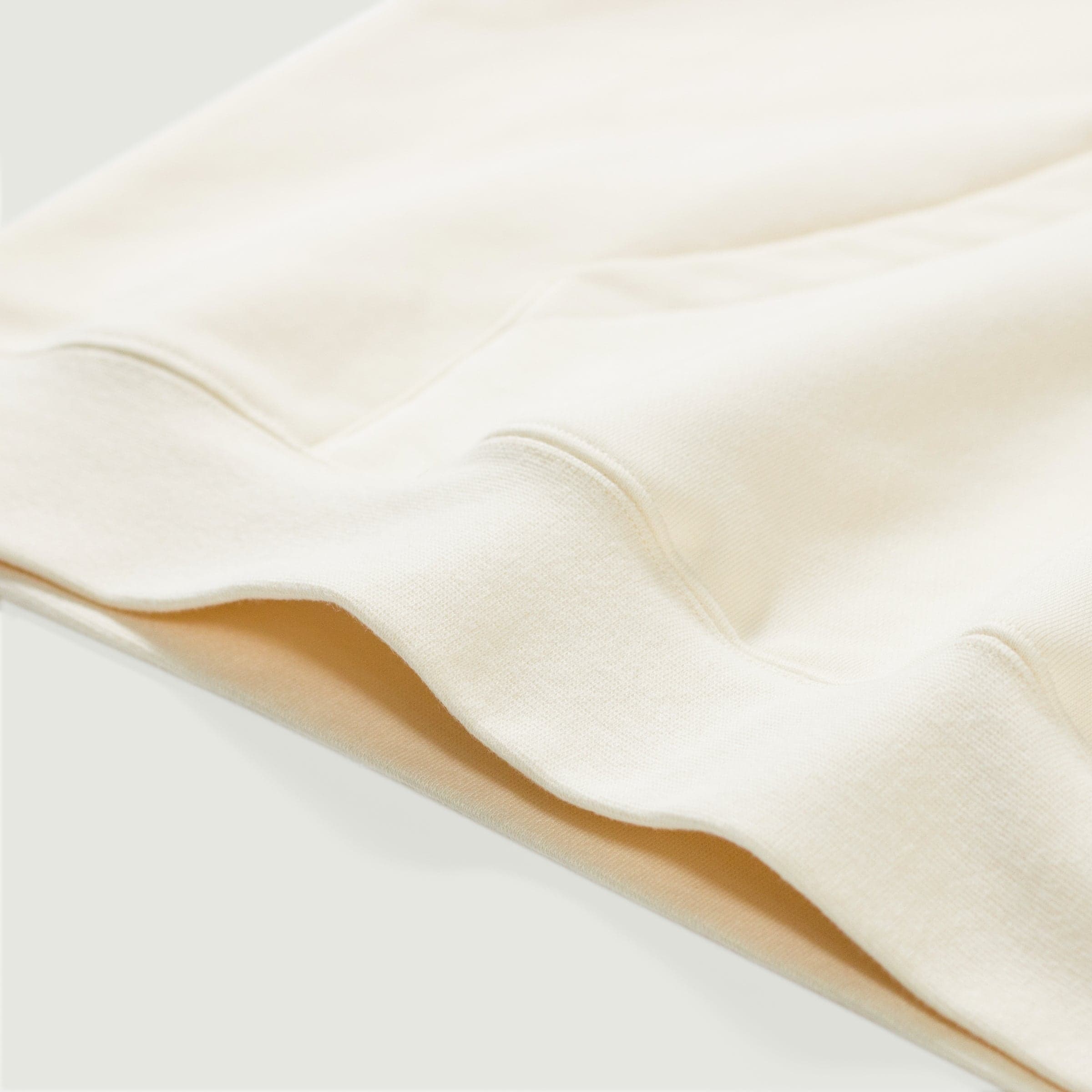 Crownfall oversized graphic hoodie hem and fabric fold close-up detail