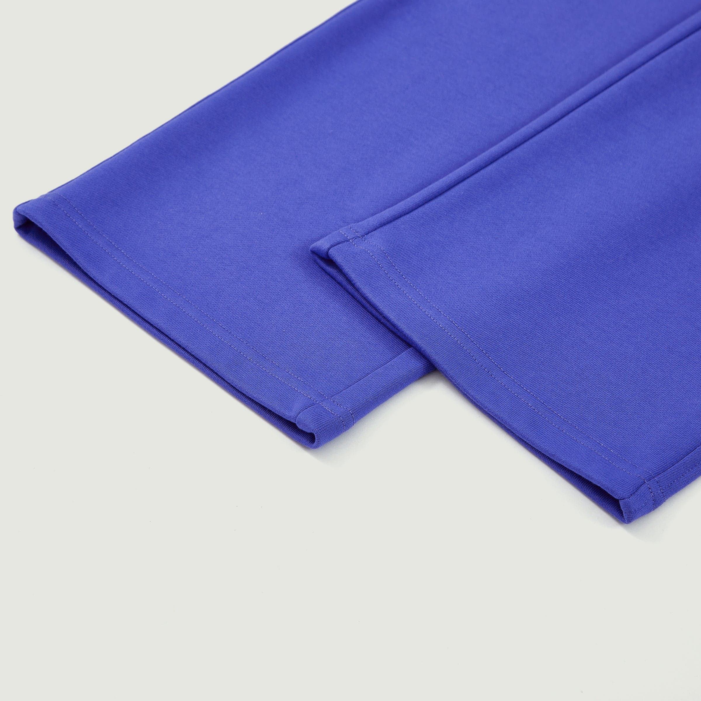 DRGN FLUX media image showing blue sample sweatpants upper leg seam close-up detail