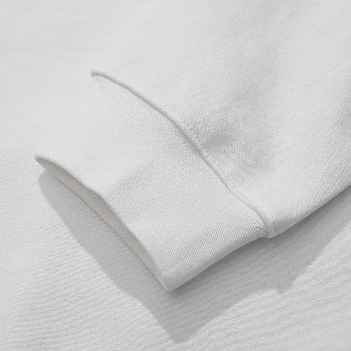 The ECLYPSE graphic print, crew neck sweatshirt features a close-up detail of the sleeve cuff, crafted from cream-colored cotton.