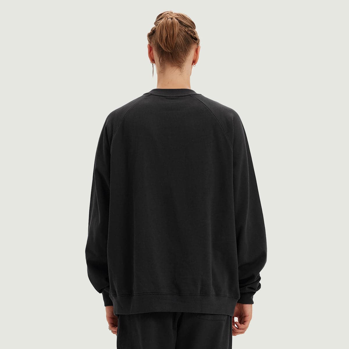ECLYPSE media image showing male model wearing a black crewneck sweatshirt back view