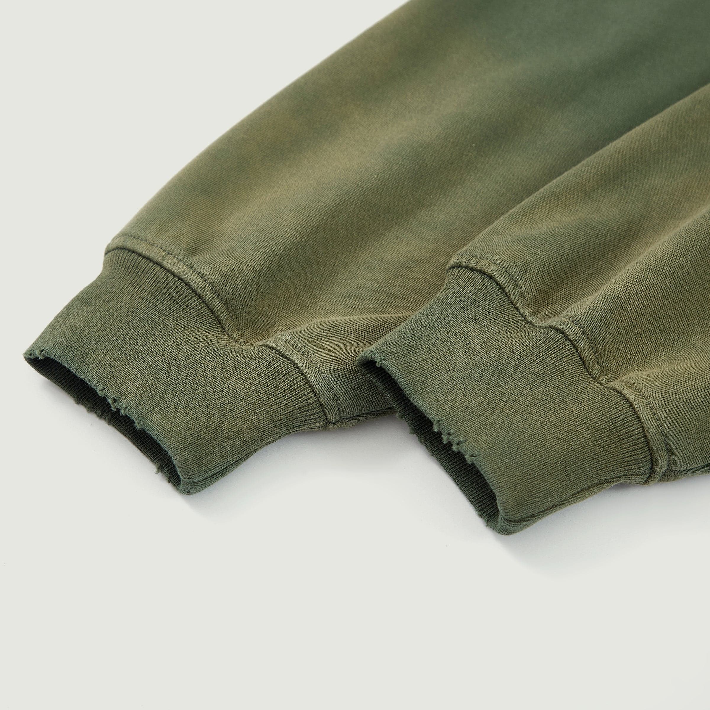 Eternal Wing media image showing green sample zip hoodie cuff close-up detail