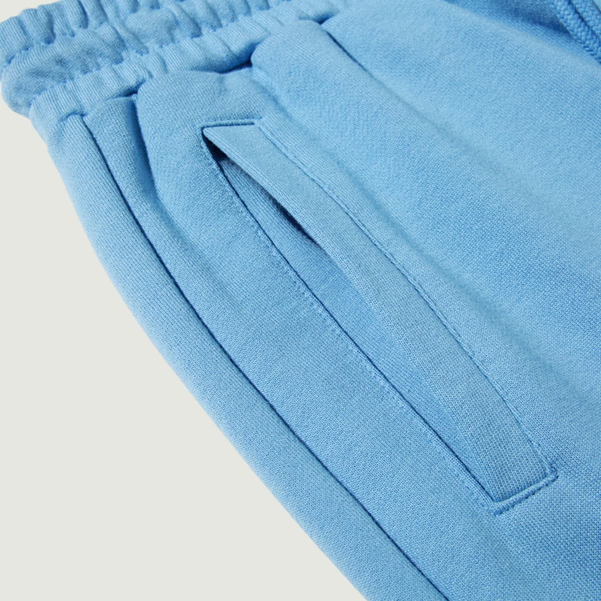 Flora media image showing blue sample sweatpants pocket close-up detail