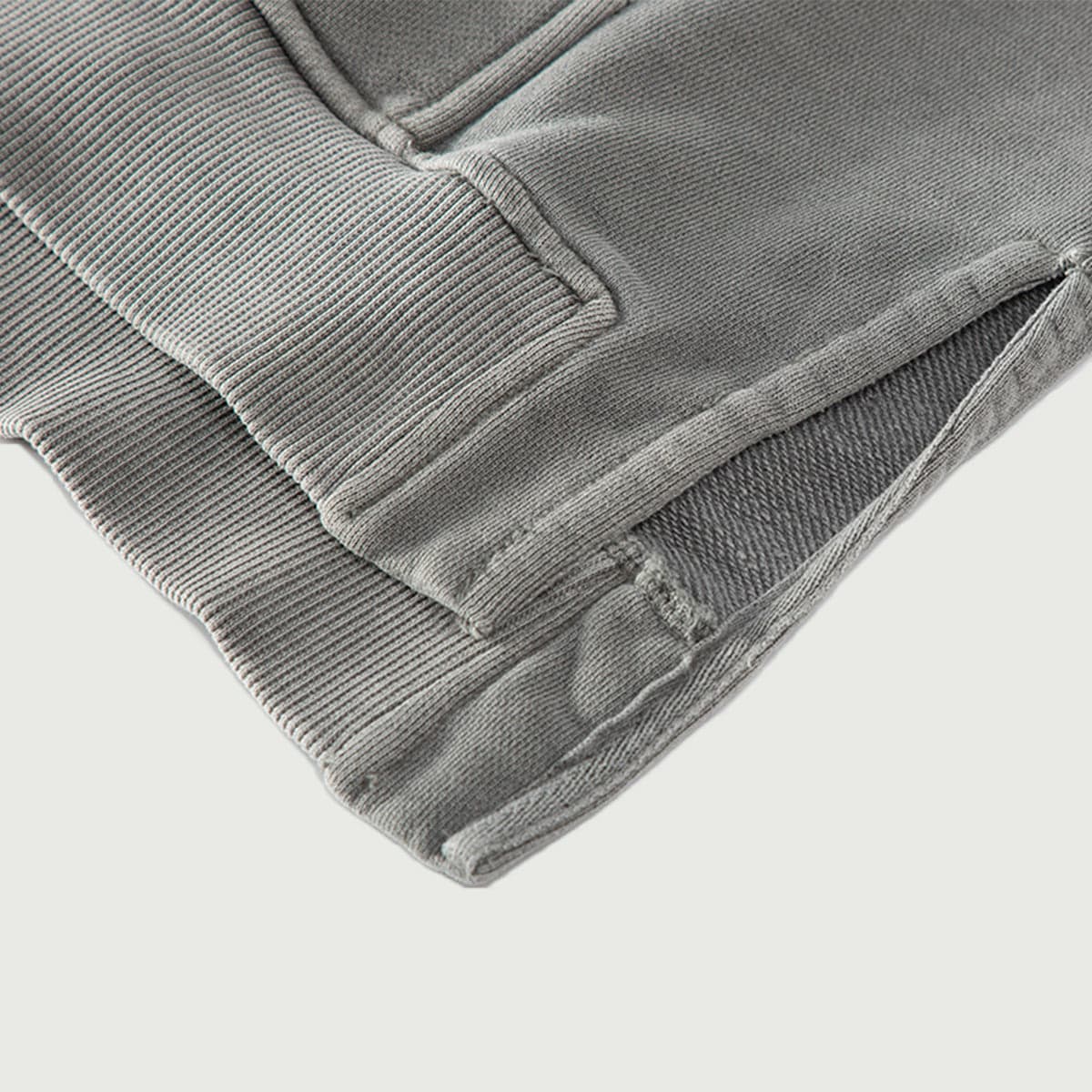 NOX media image showing grey sample hoodie high-low split hem close-up detail