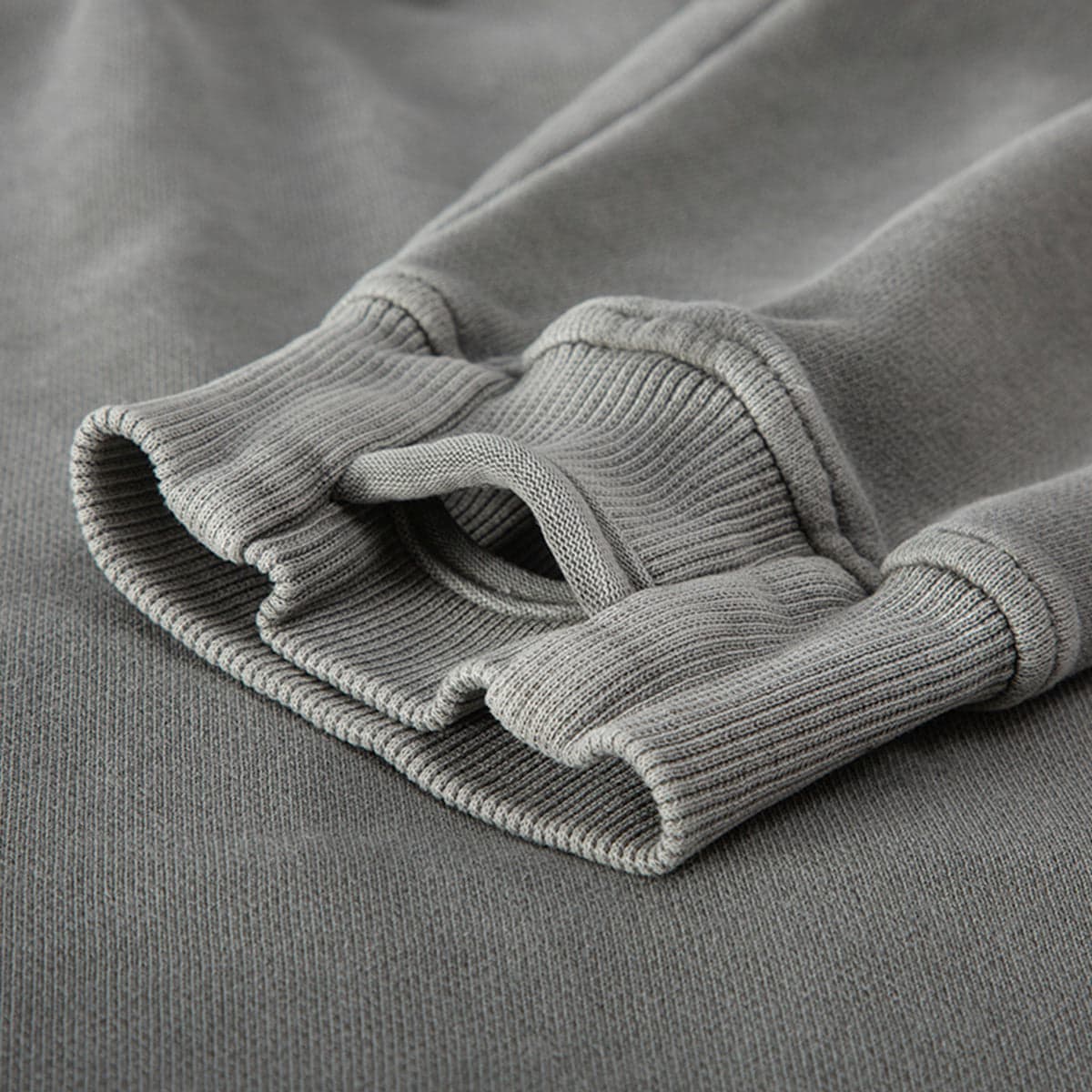 NOX media image showing grey sample hoodie thumb hole cuff close-up detail