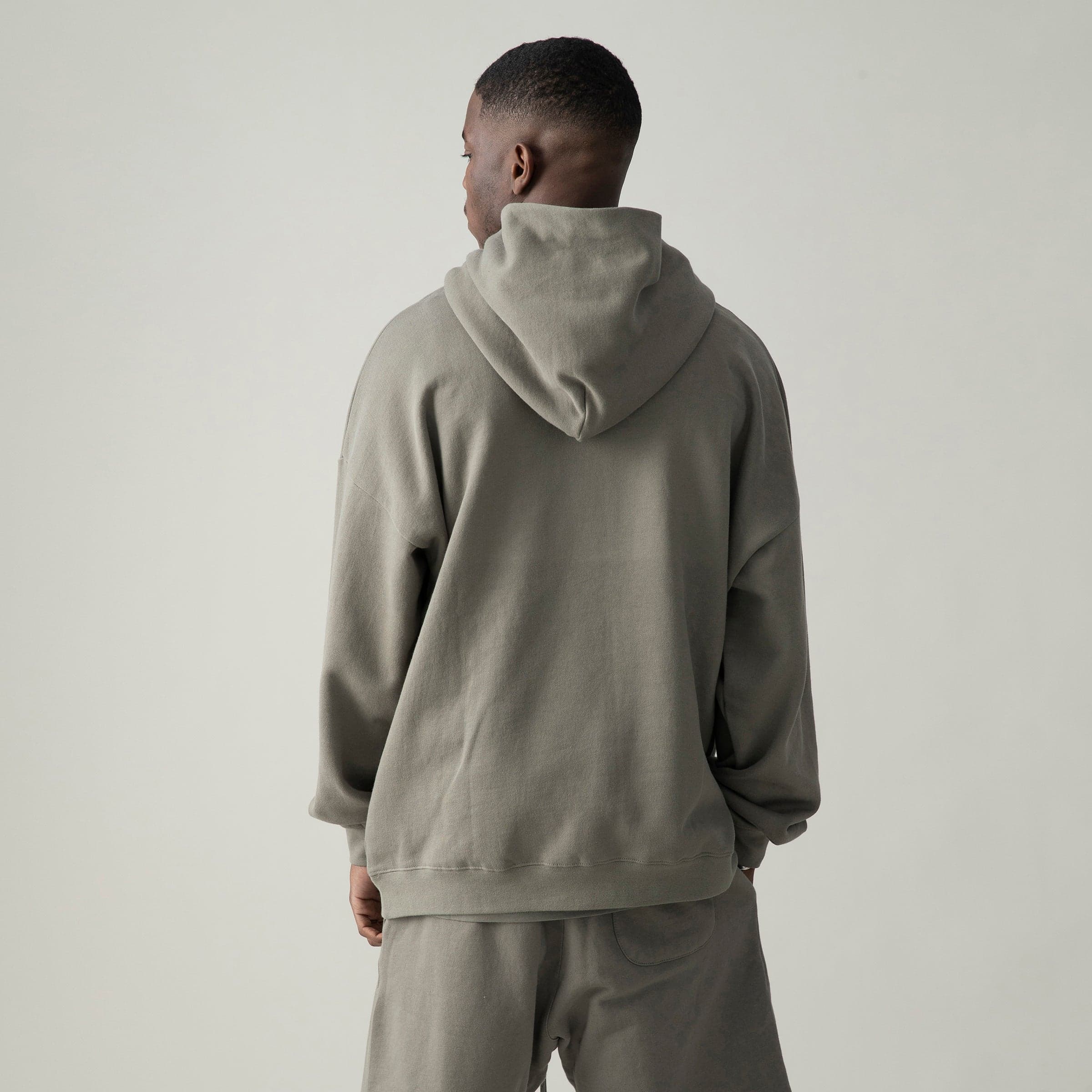 Pulsecore media image showing male model wearing a taupe loose fit hoodie back view