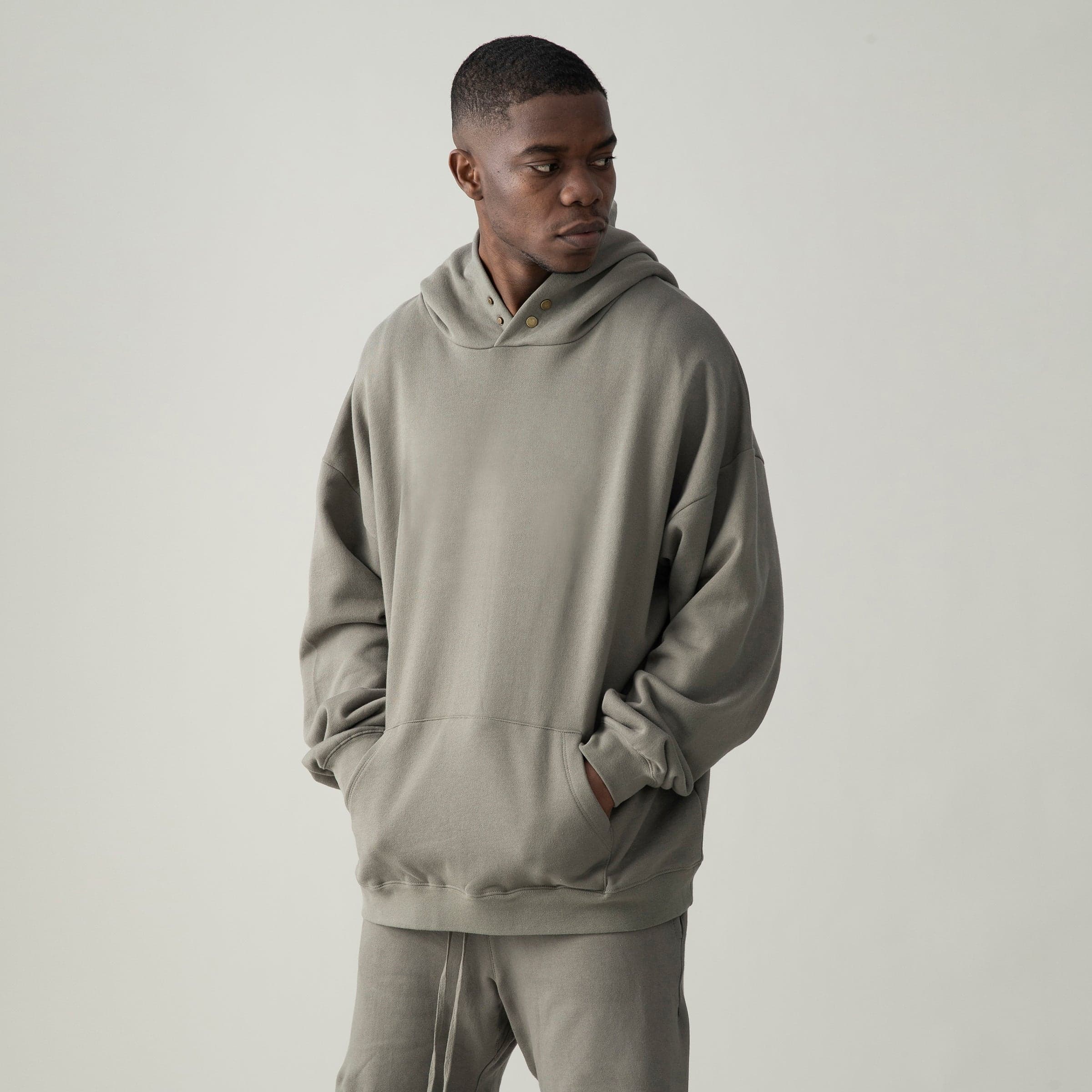 Pulsecore media image showing male model wearing a taupe loose fit hoodie angled front view