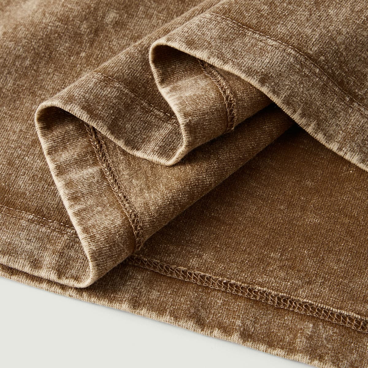 Quantum Veil media image showing brown washed tee folded sleeve and hem detail