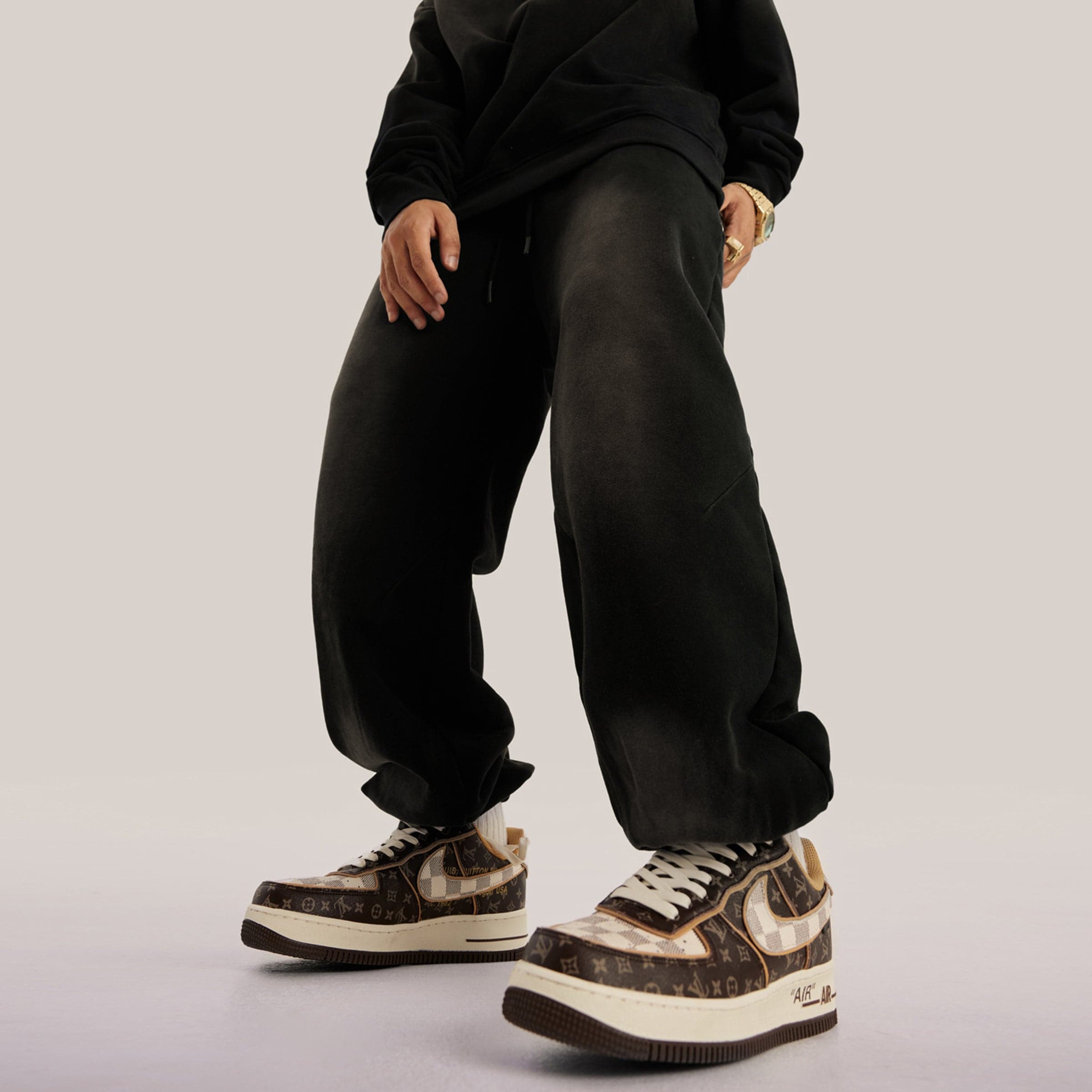 REIGN embroidered sweatpants angled side fit view on model