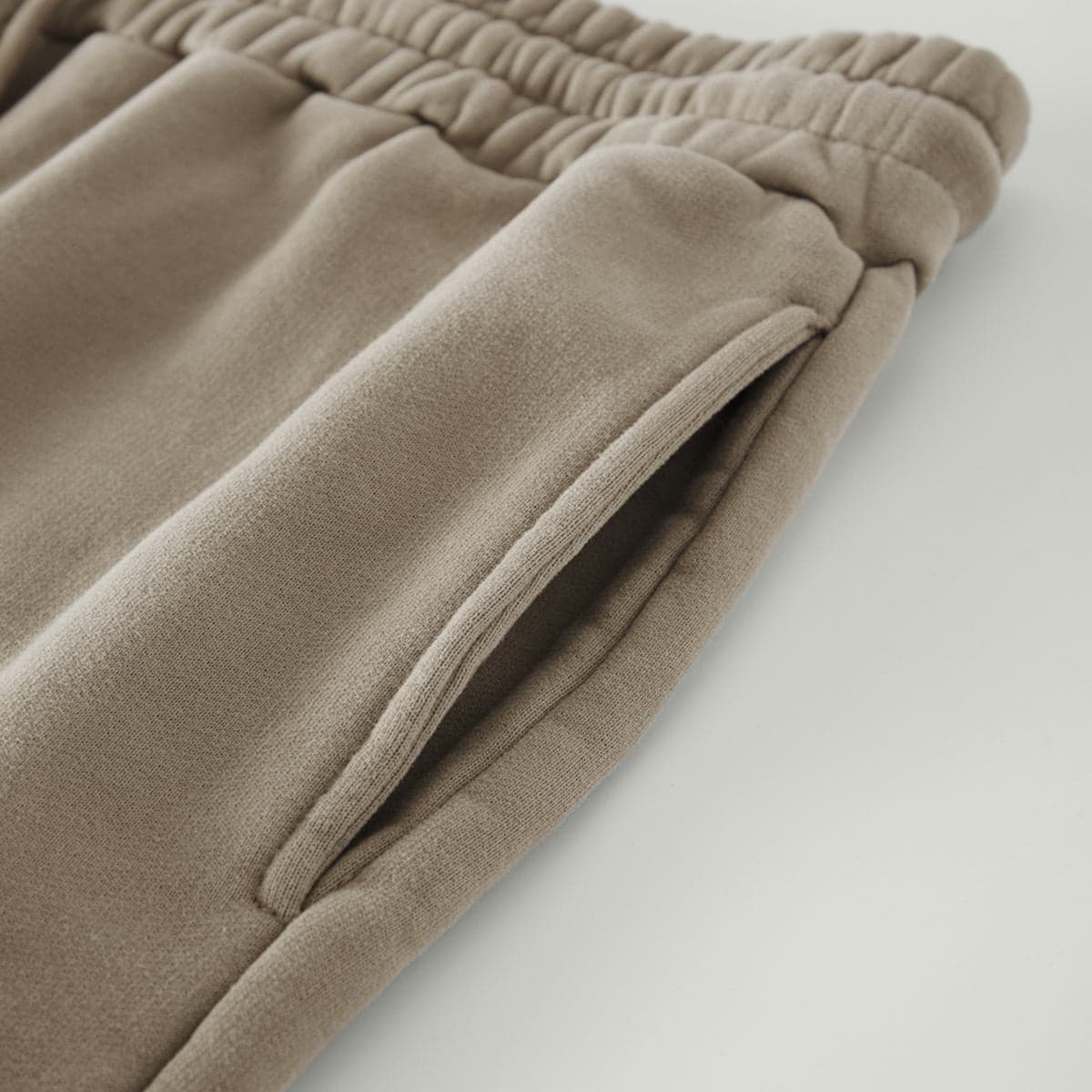 REIGN media image showing beige sample sweatpants pocket close-up detail