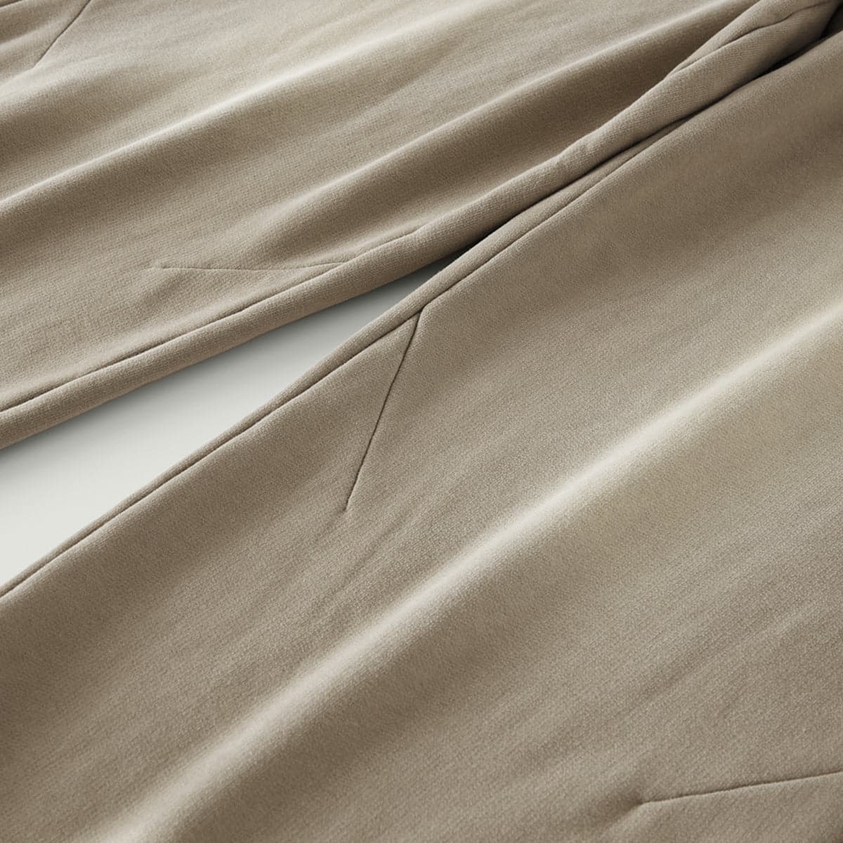 REIGN media image showing beige sample sweatpants side seam close-up detail