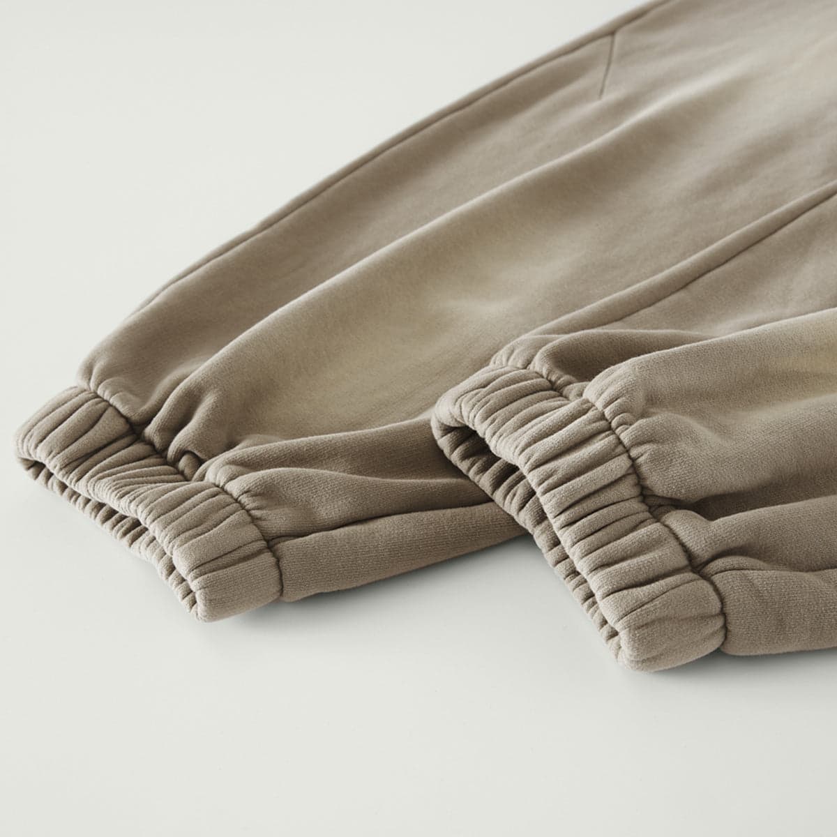 REIGN media image showing beige sample sweatpants fabric texture close-up detail