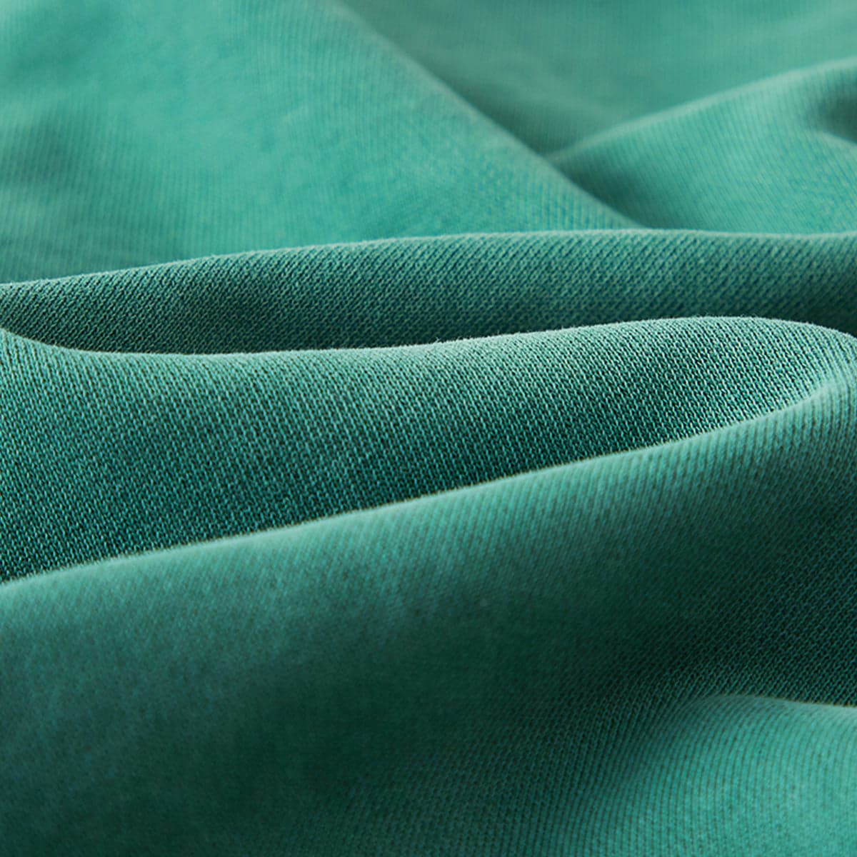 Relic media image showing green sample sweatpants fabric texture close-up detail