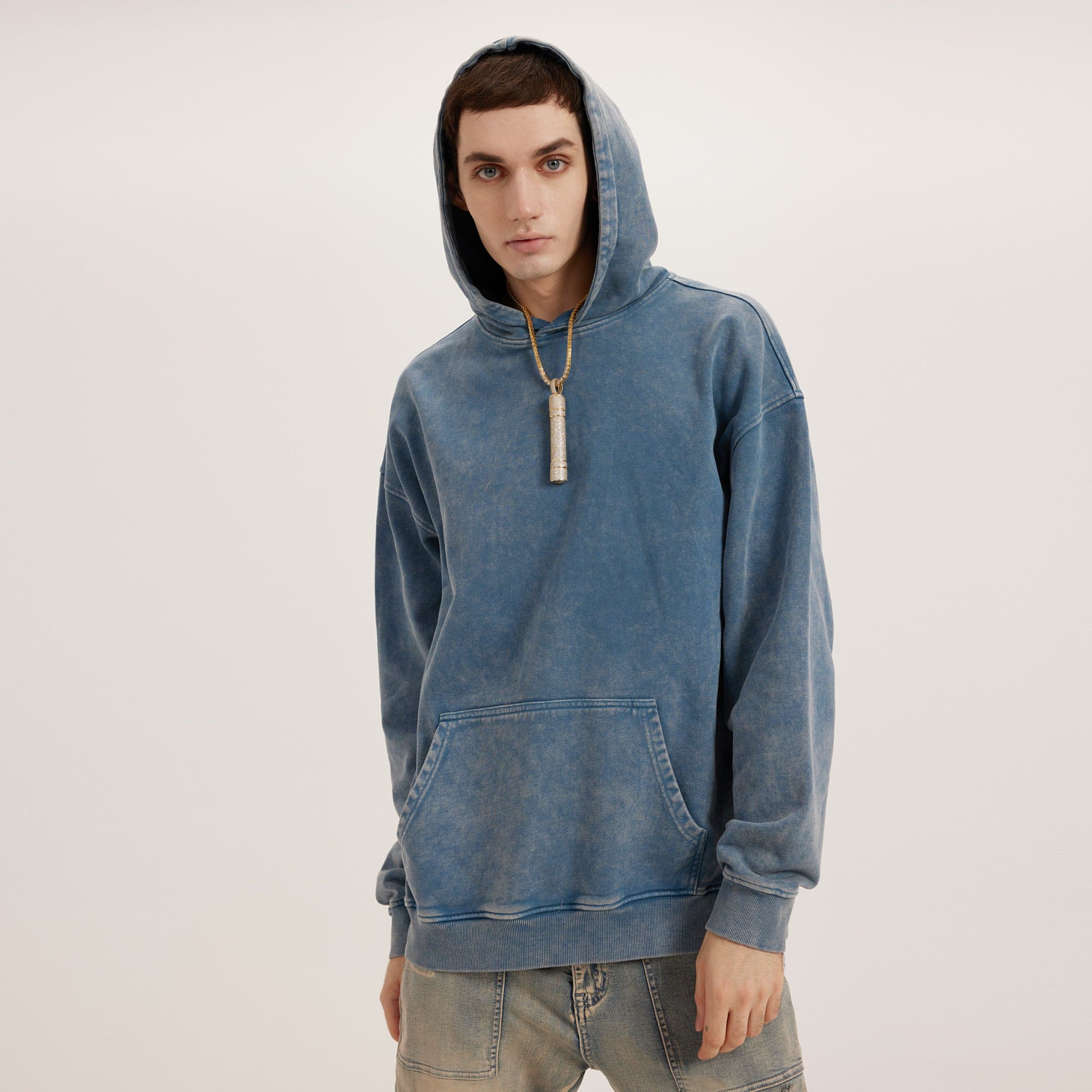 Rooted Spiral media image showing male model wearing a blue washed oversized hoodie front side view