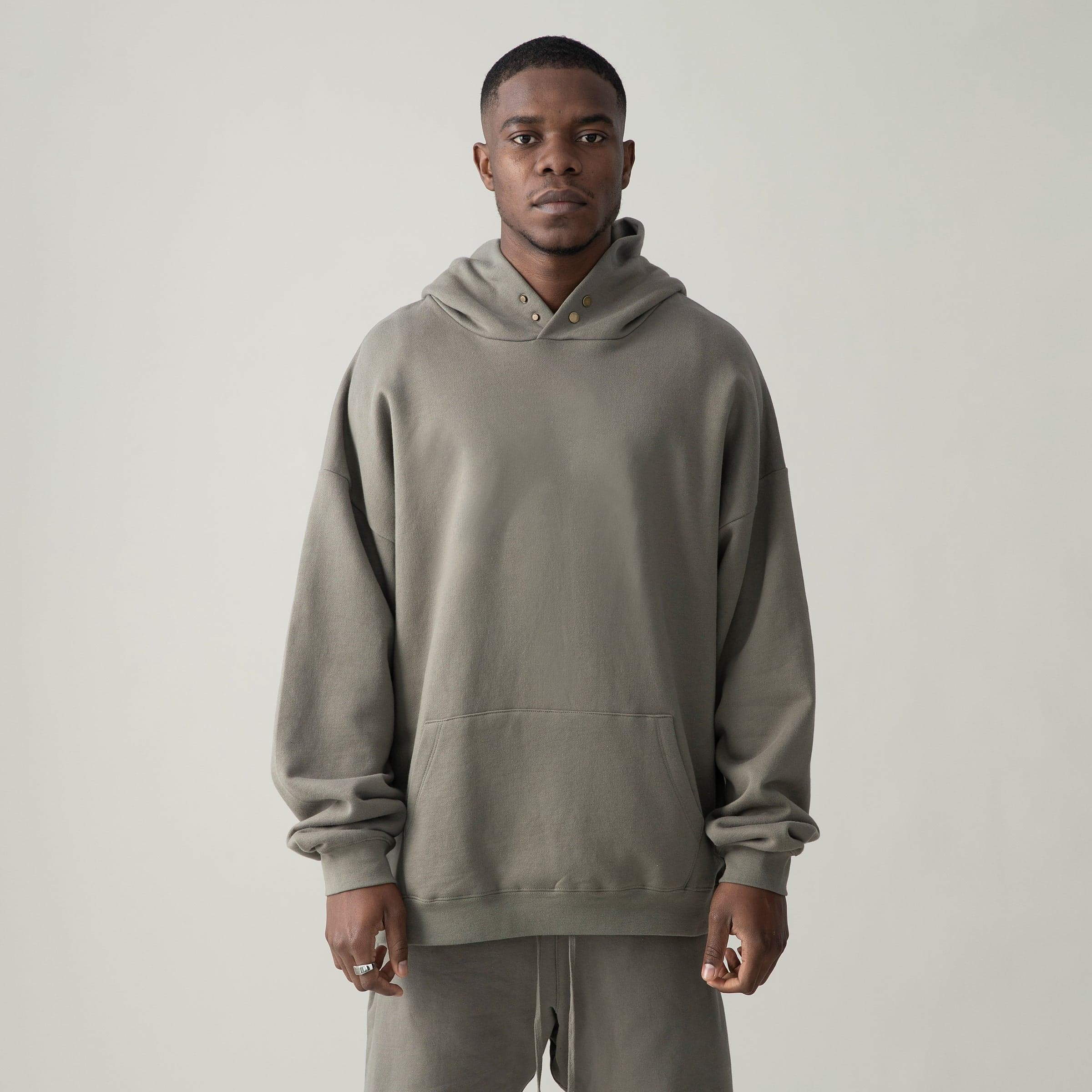 VineSigil media image showing male model wearing a taupe loose fit hoodie front view