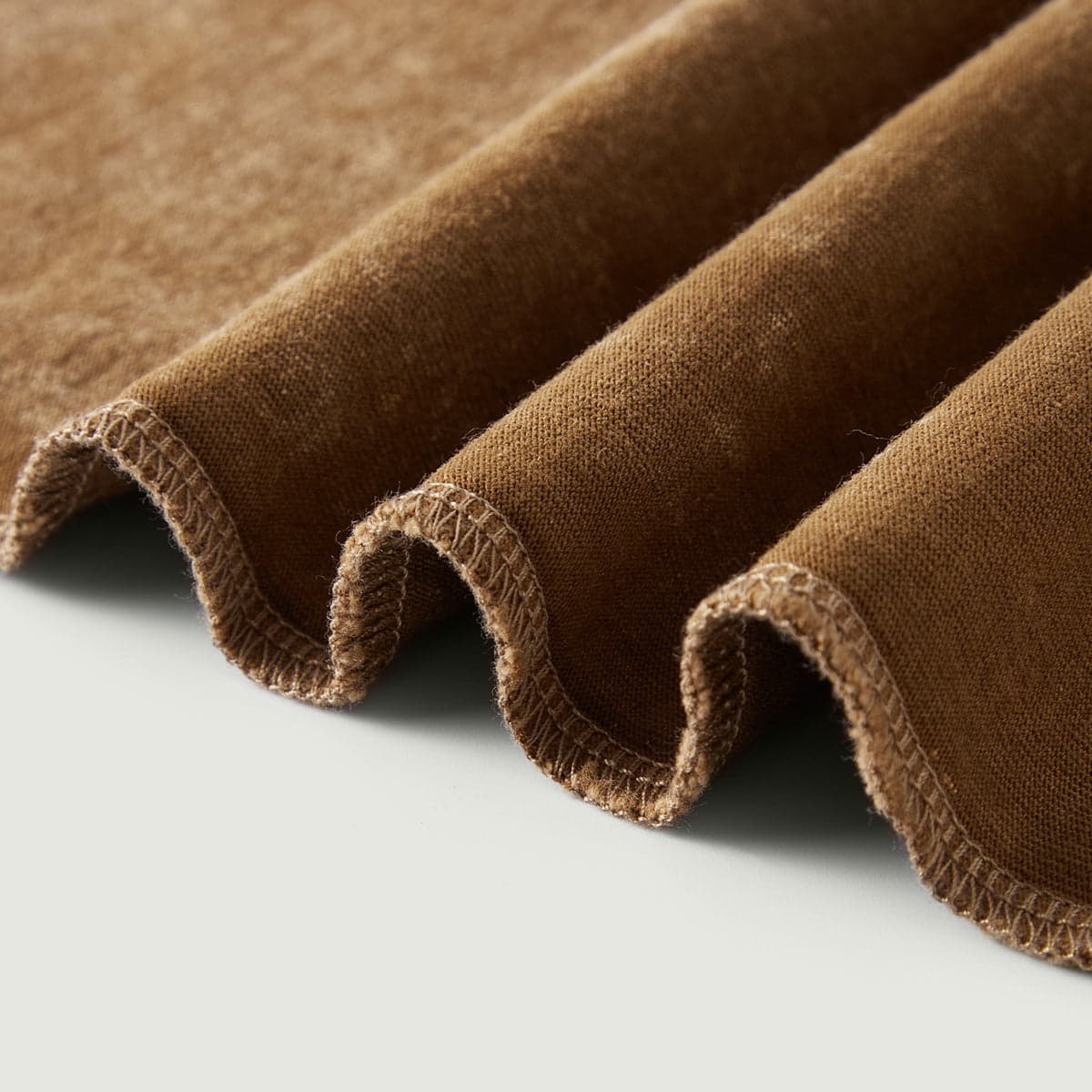 Vintage Beige media image showing brown washed tee hem edge close-up detail
