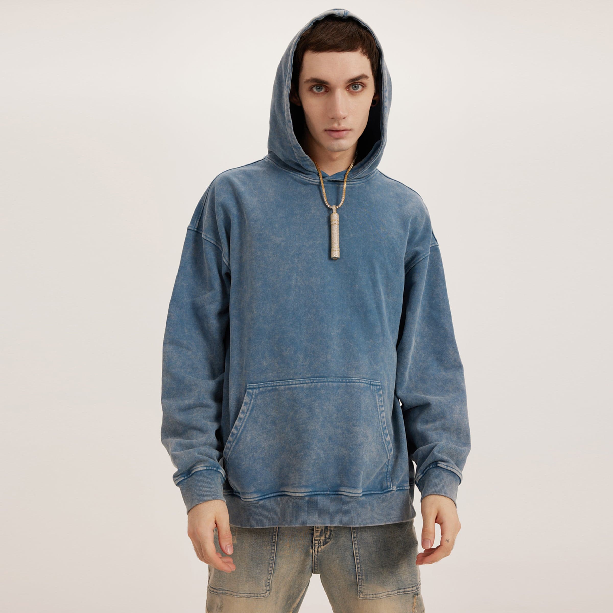 Rebirth media image showing male model wearing a blue washed oversized hoodie full body front fit