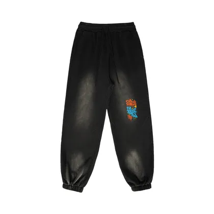 REIGN embroidered sweatpants front view in washed black with leg embroidery